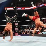 Xavier Woods and Paige thrilling wrestling match in vibrant arena.